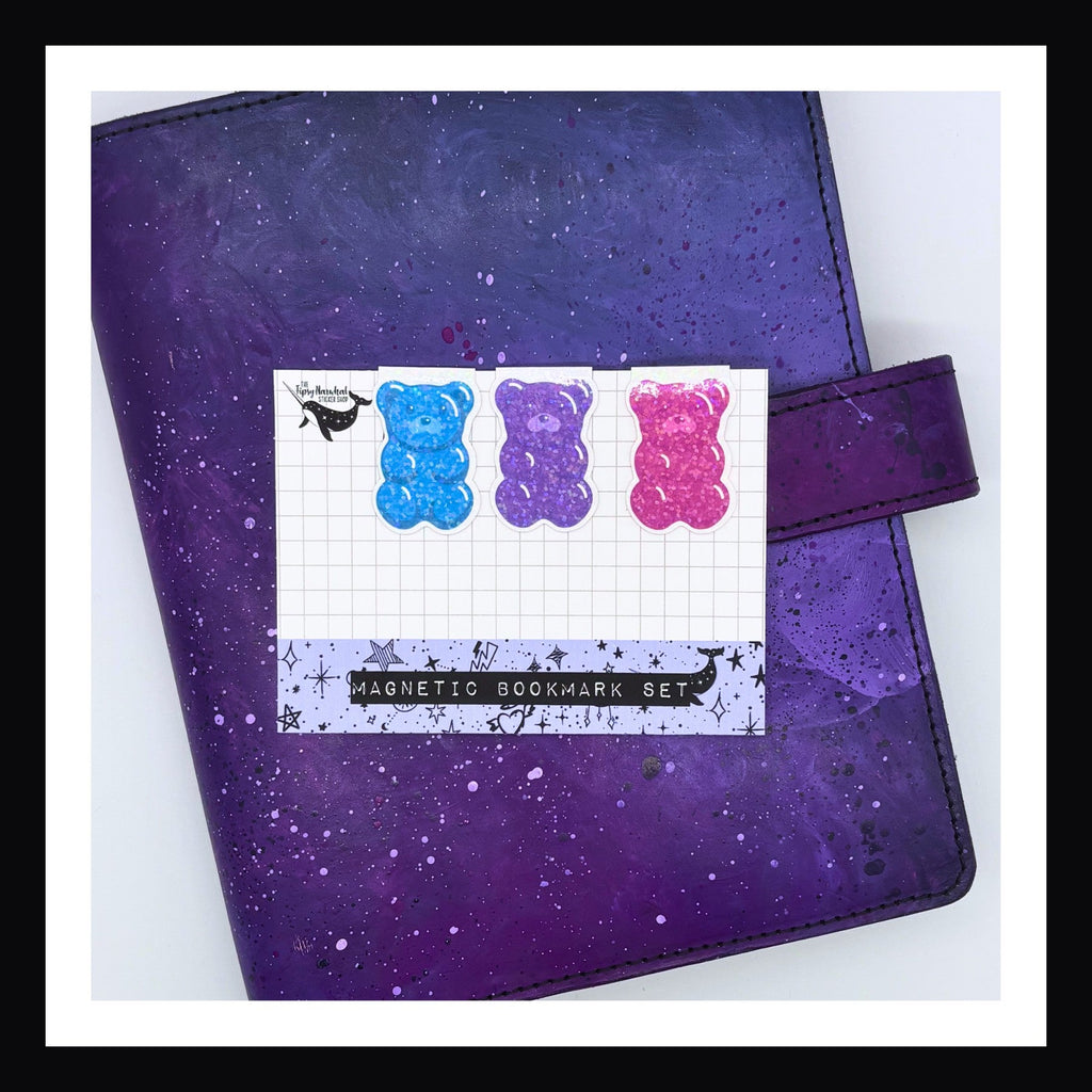 Magnetic Bookmark - Gummy Bear Trio in Teal, Purple, & Pink shown on a purple planner.