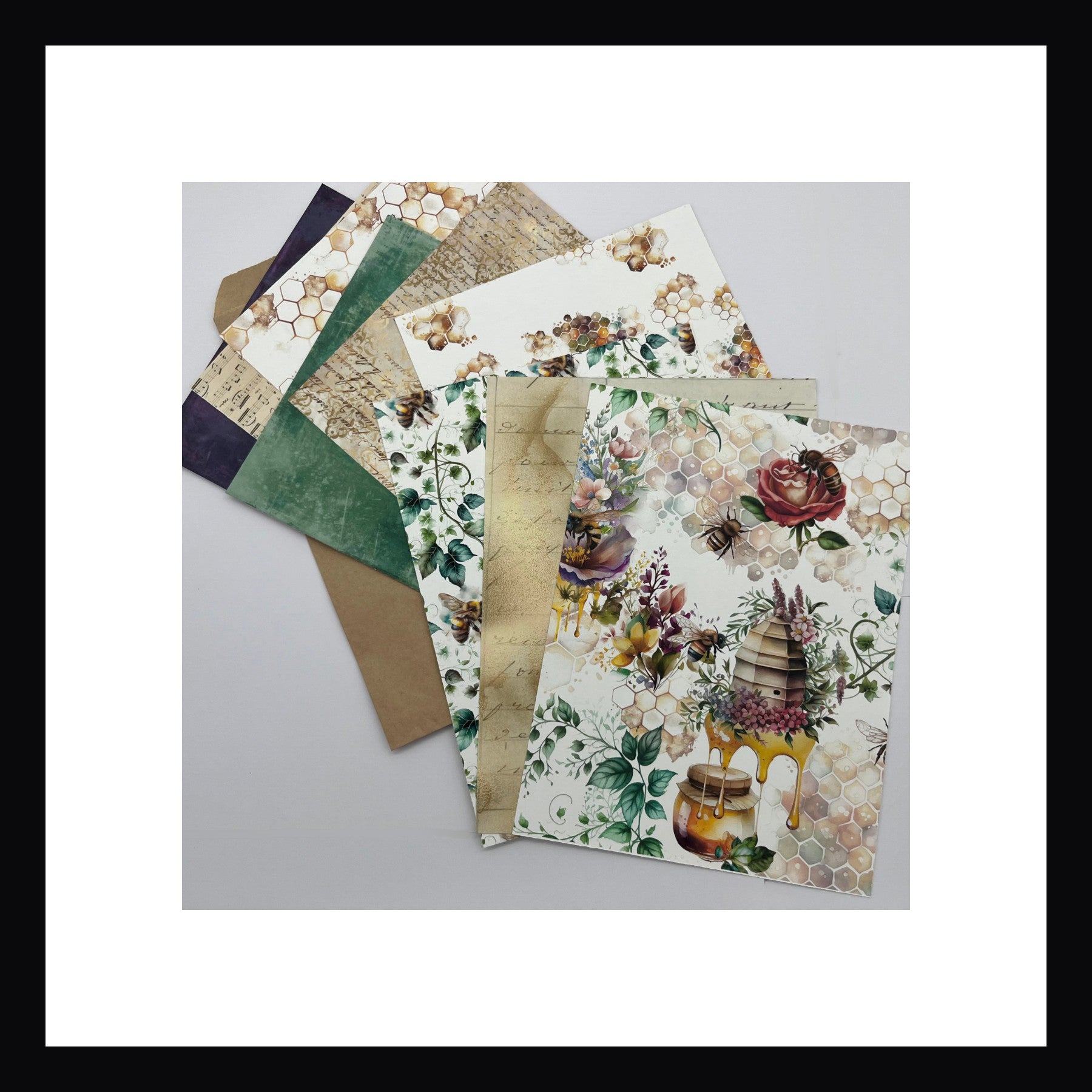 Bees & Honey Junk Journaling Kit papers. Kit includes 12 double sided papers all measuring 6"x8".  Papers include watercolor floral patterns, aged music, antique writings and honeycomb patterns.