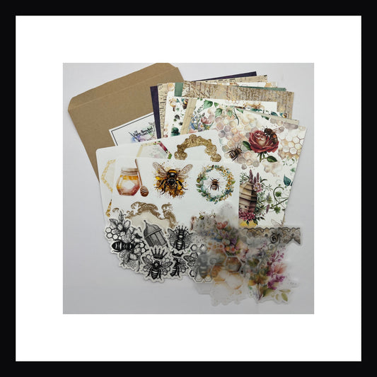 Bees & Honey Junk Journaling Kit features 12 double sided papers, 2 sheets of stickers, 5 clear die cut stickers and 6 vellum accents.  Bee themed kit has a vintage feel with watercolor floral art mixed with antique and aged papers. 
