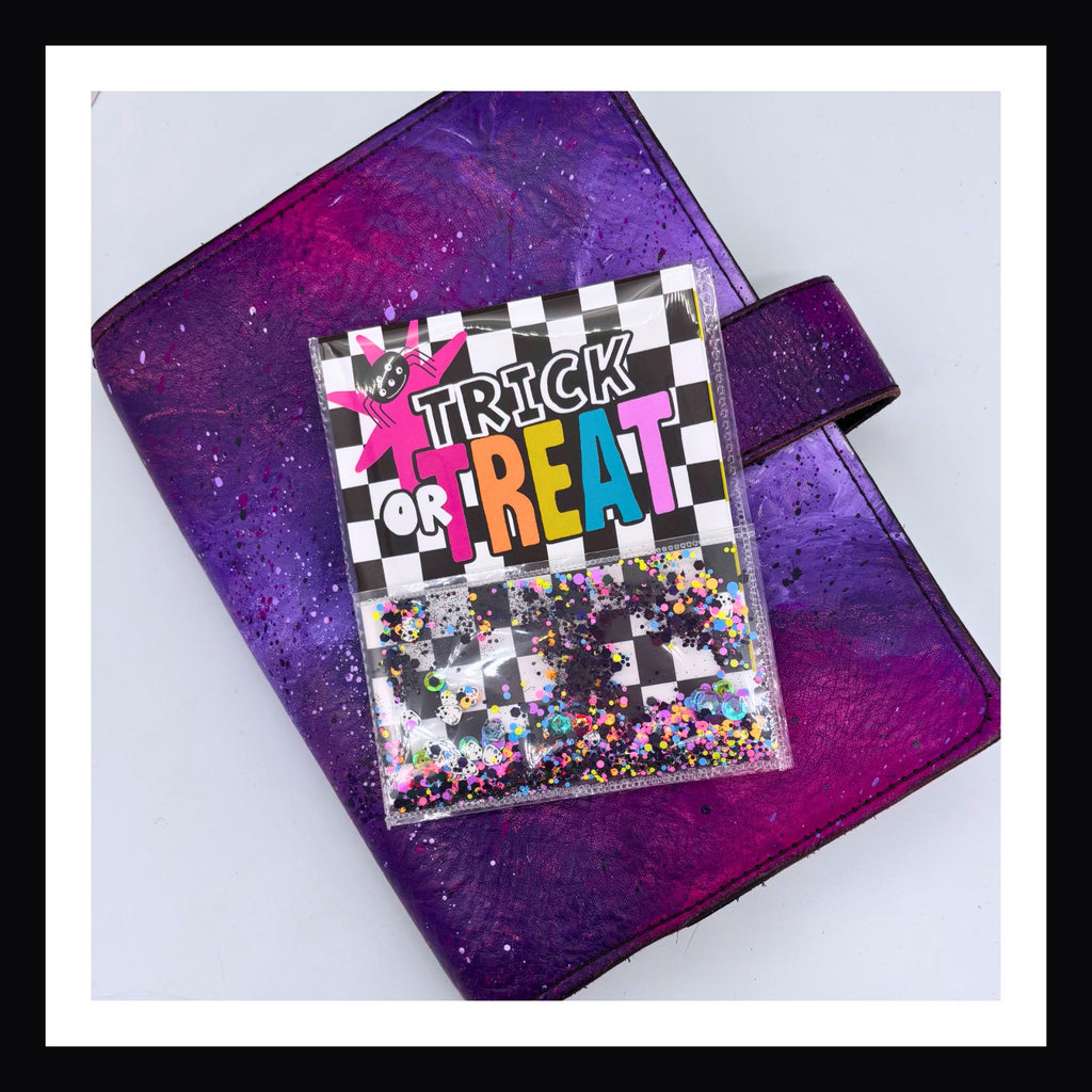 Bright Halloween Shaker Pocket shown on purple planner.  The shaker part is filled with black and neon glitter.  