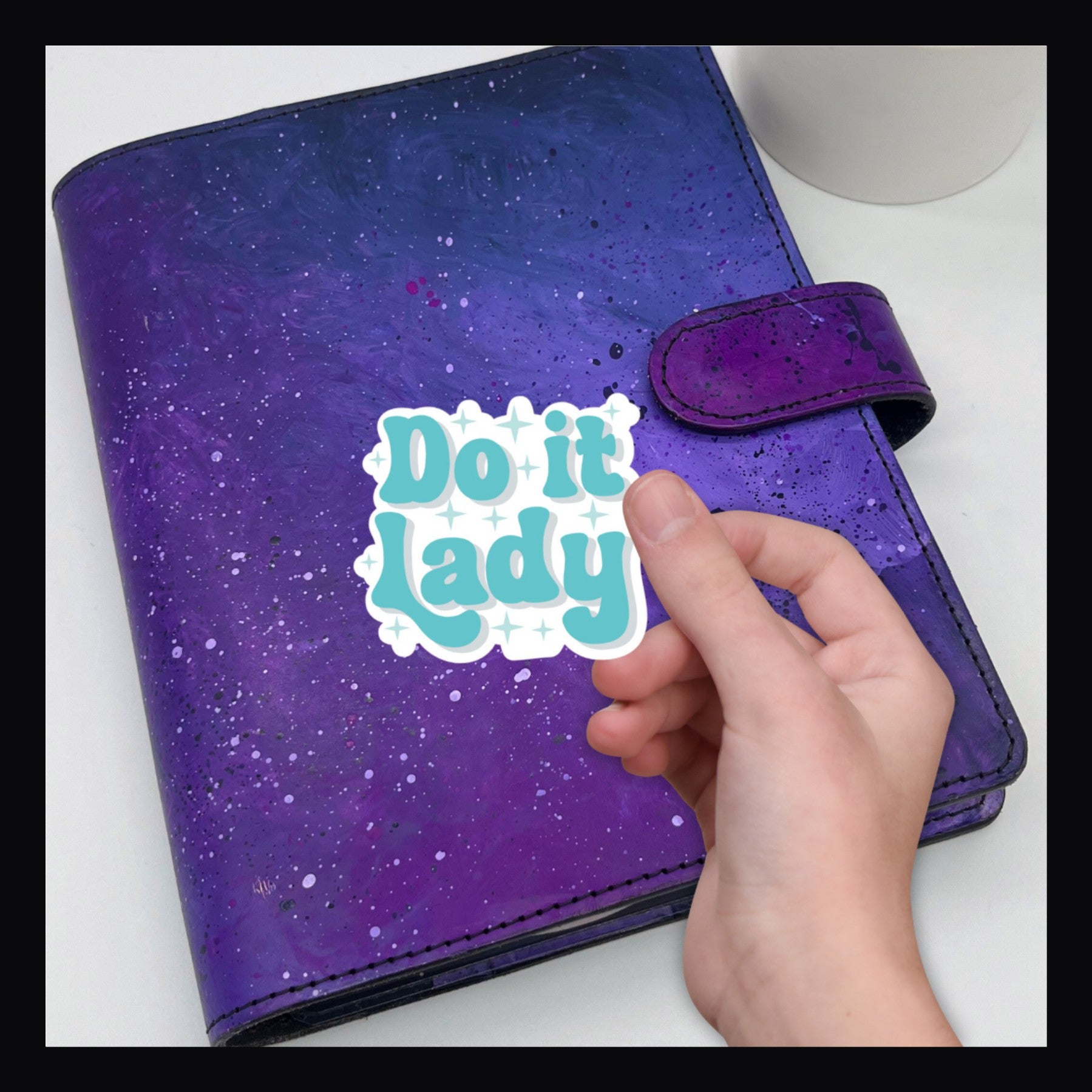 Do It Lady Die Cut, shown on a purple planner. 
