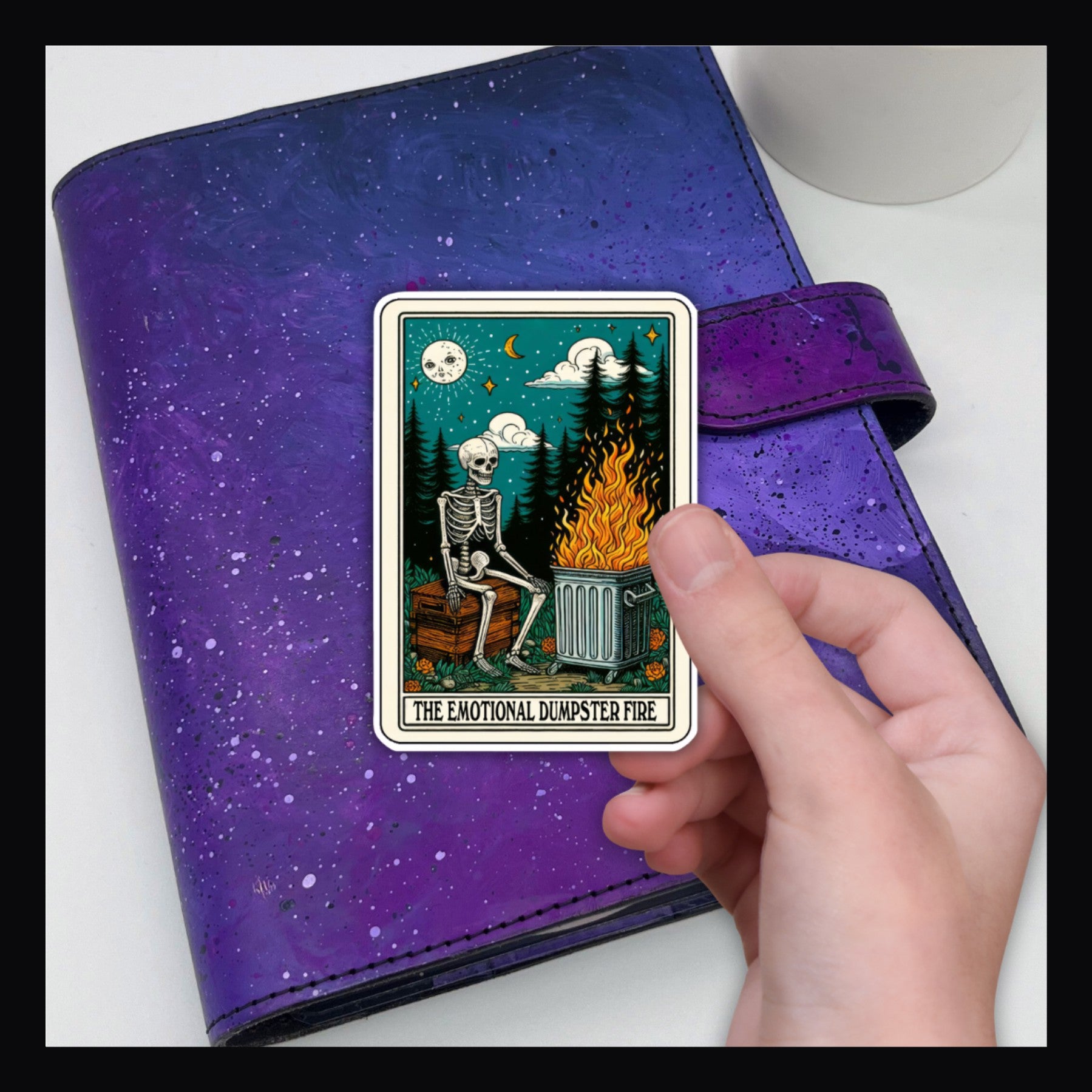 Alternative Tarot Die Cut - Emotional Dumpster Fire shown here on a purple planner.