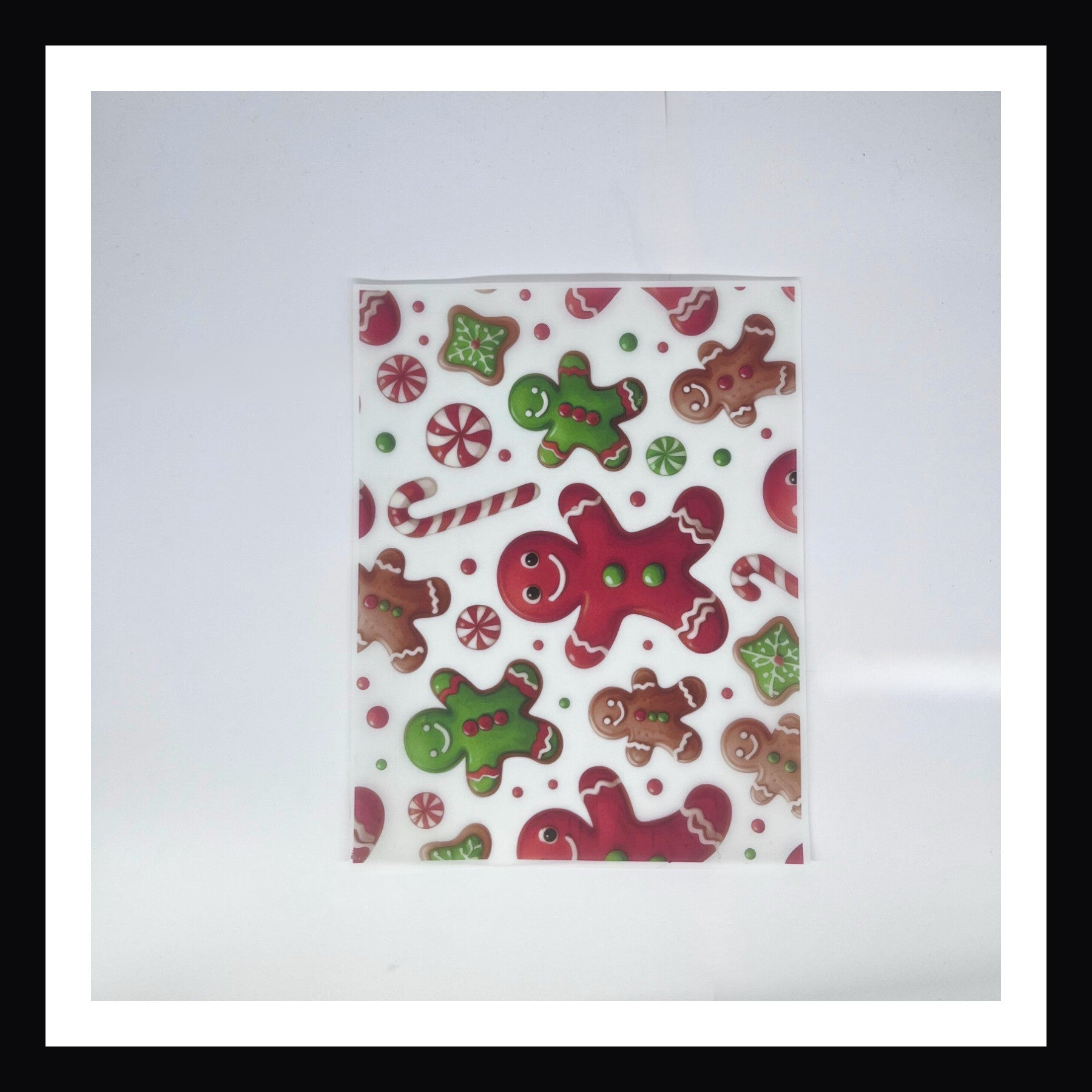 Christmas Morning Vellum - Christmas Morning Gingerbread Men is a 8x10 sheet of printed vellum. This cheerful design features a collection of gingerbread men, candy canes, peppermint twists and other goodies seen during the holiday season. 
