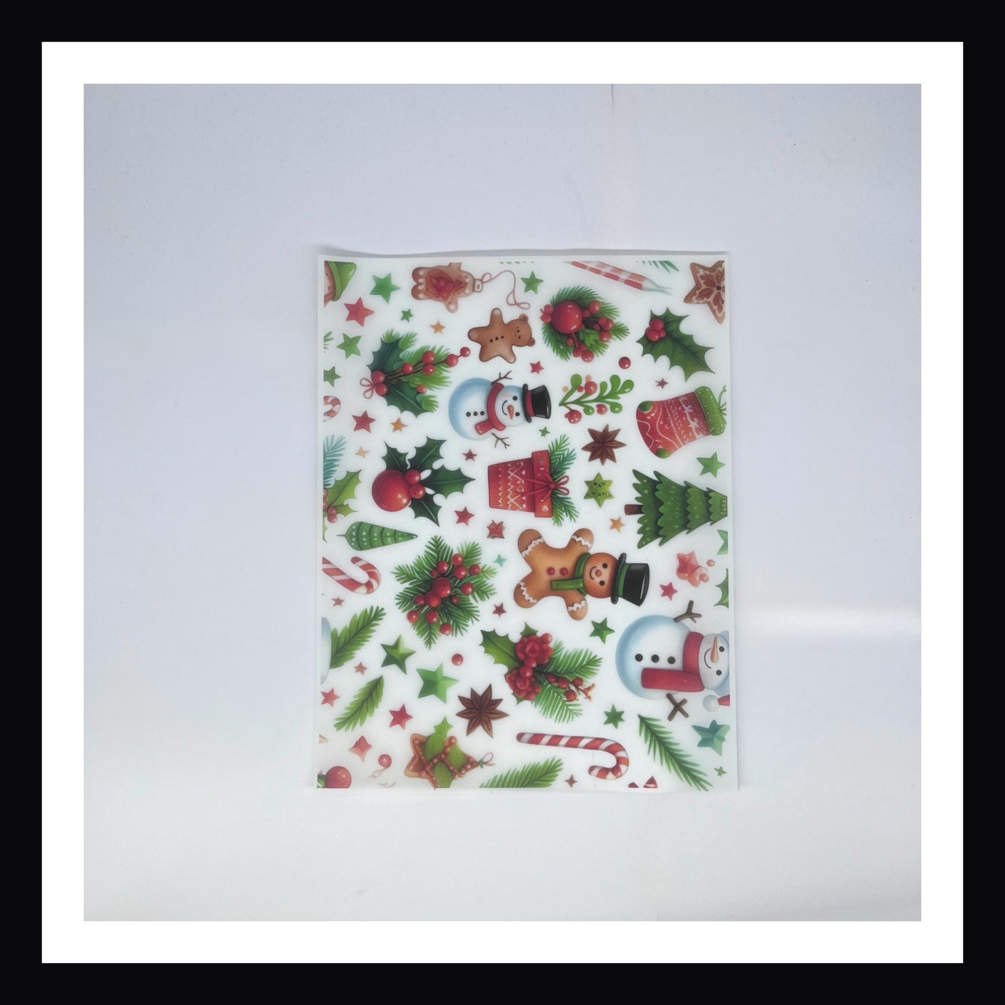 Christmas Morning Vellum - Holly Jolly Mix is a 8x10 sheet of printed vellum.  This vellum features a collection of traditional Christmas imagery including snowmen, gingerbread men, candy canes, holly and more. 