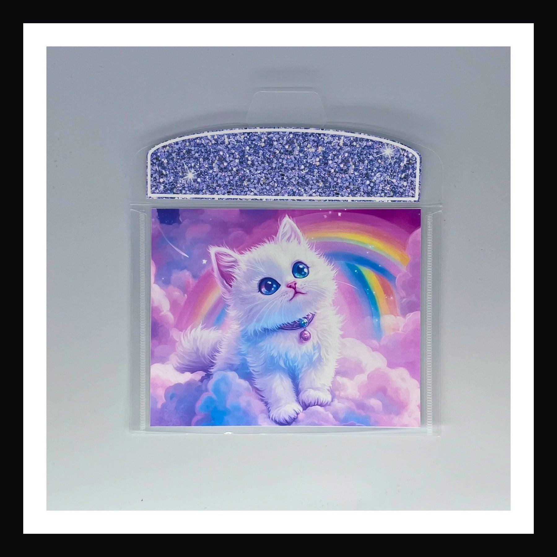 Bright 90s Style Envelope - White Kitten print features a fluffy white kitten sitting on clouds with rainbows in the distance.  Flap color is a pastel lavender. 