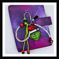 Loathe Entirely Carabiner Bag Charm features a handmade Grinch charm, a paracord knot with beads and two friendship-bracelet-style beaded tags that collectively read "Hate, hate, hate. Double hate. Loathe entirely".