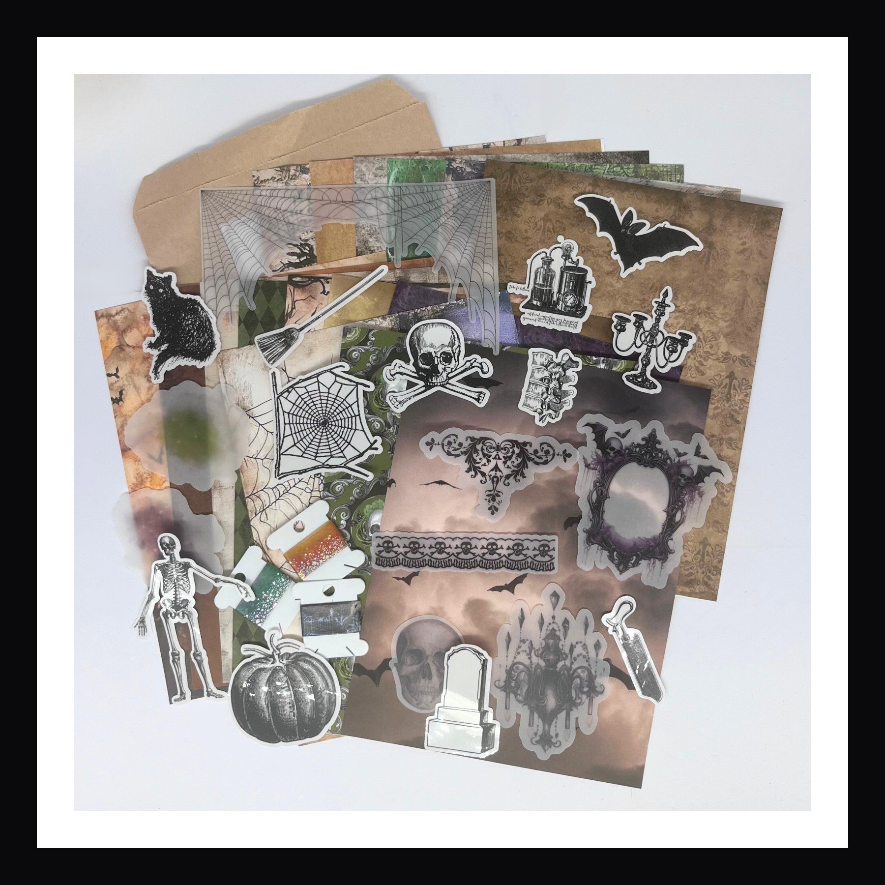 Deluxe Halloween Junk Journal kit features paper, vellum elements, stickers, clear glossy sticker and washi tape all with a spooky Halloween theme. 