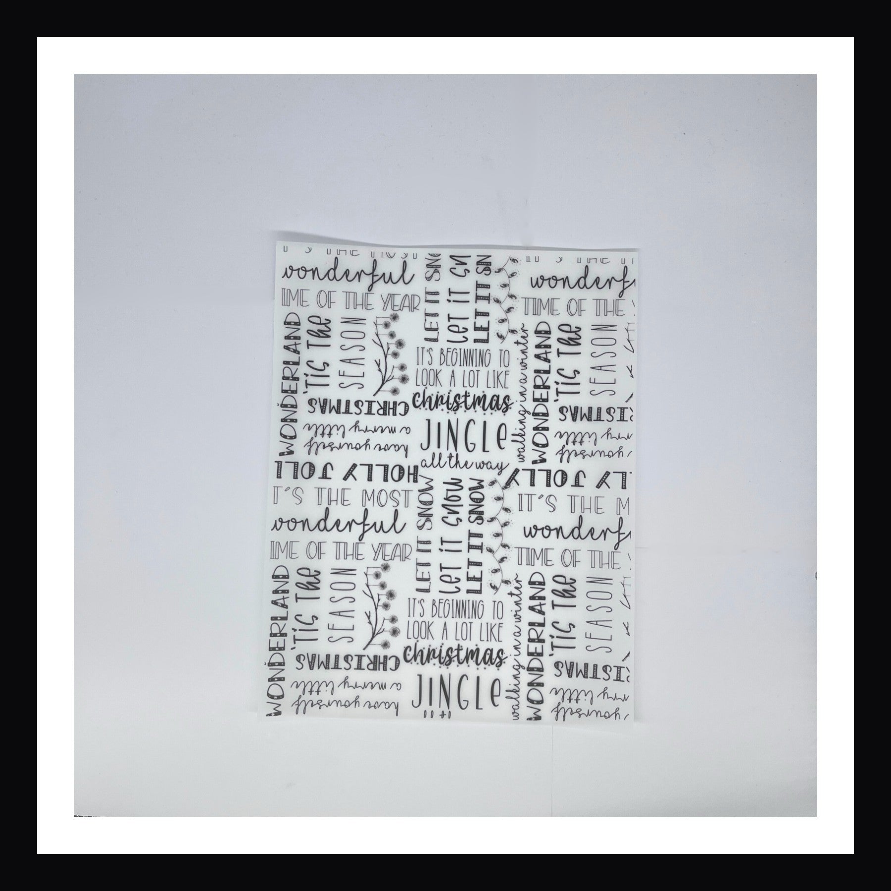 Monochromatic Christmas Vellum in Monochromatic Holiday Tidings.  This 8x10 sheet of vellum is printed with various holiday phrases.  Different fonts and orientations provide visual interest to this black and white print. 