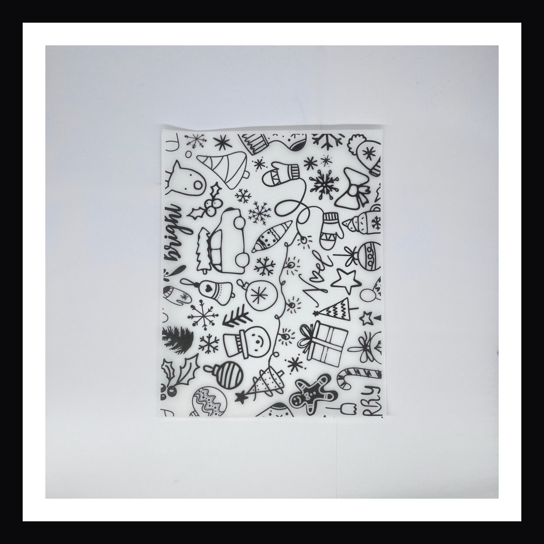 Monochromatic Christmas Vellum in Monochromatic Christmas Doodles.  A 8x10 sheet of printed vellum featuring a selection of various popular Christmas iconography.  This black and white print is done in a doodle-like style. 