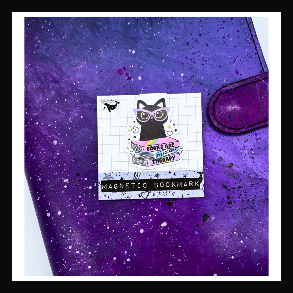 Magnetic Bookmark - Books Are My Therapy double sided bookmark shown her on top of a purple planner.