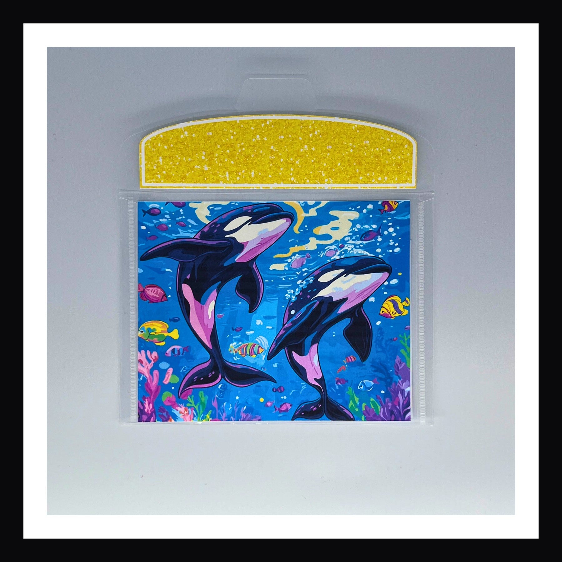 Bright 90s Style Envelope - Orcas features two Orca whales swimming in a bright coral reef with tropical fish.  Flap closure is a bright citrus yellow. 