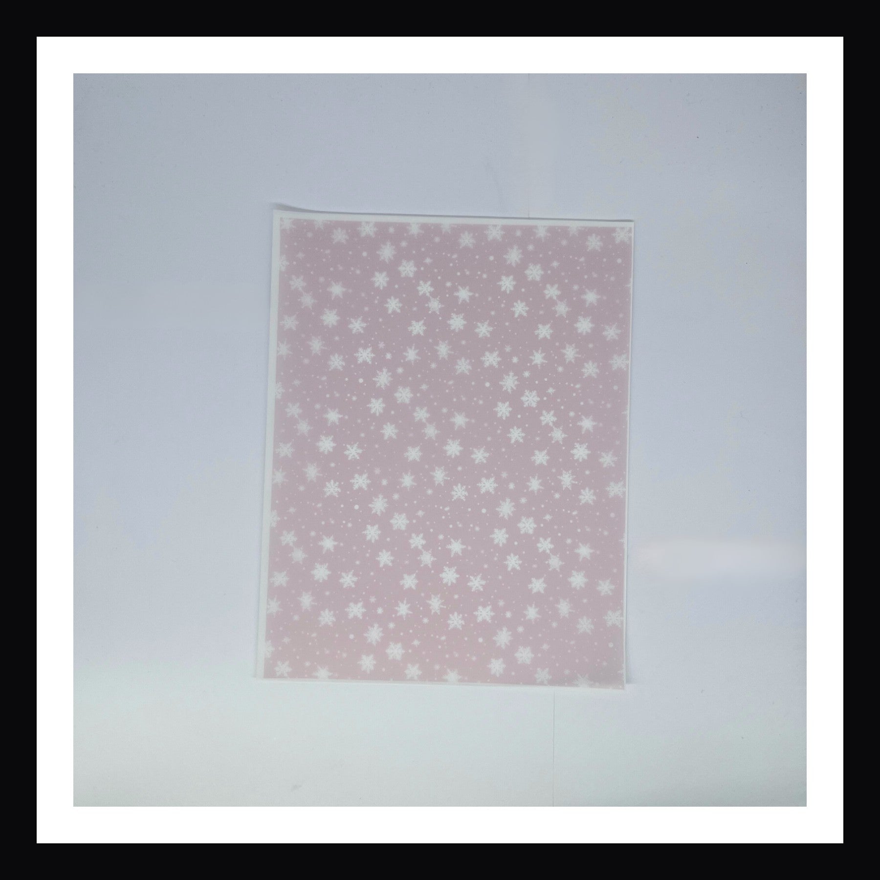 Pink Christmas Vellum - Pink Snowflakes.  A 8x10 sheet of vellum featuring white snowflakes on a delicate pink background. 