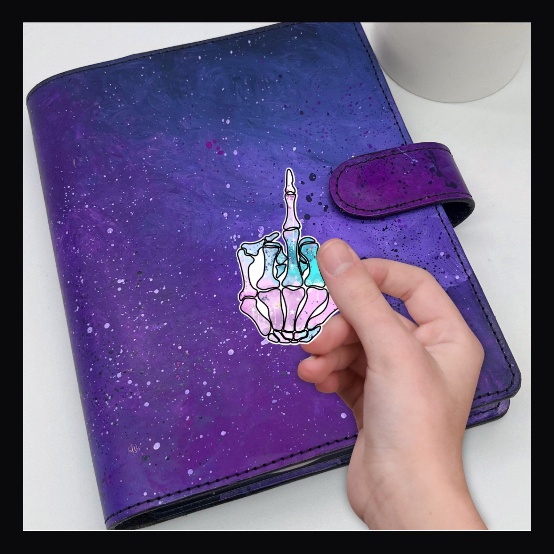 Skeletal Finger Die Cut. Sticker shown on a purple planner.