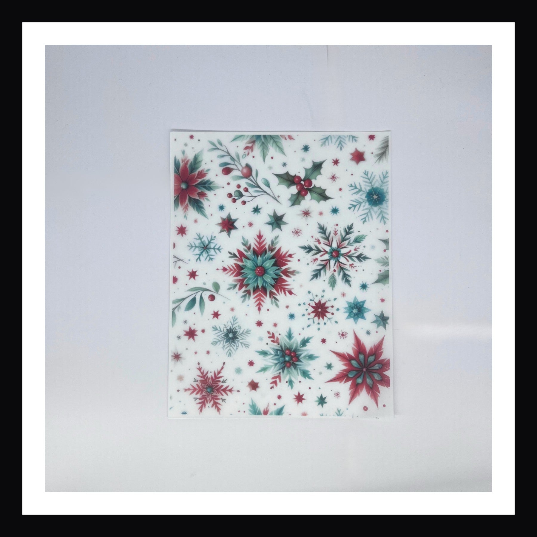 Christmas Morning Vellum - Snowflakes is a 8x10 sheet of printed vellum.  This sheet features a design of intricate stylized snowflakes in an array of reds and greens. 