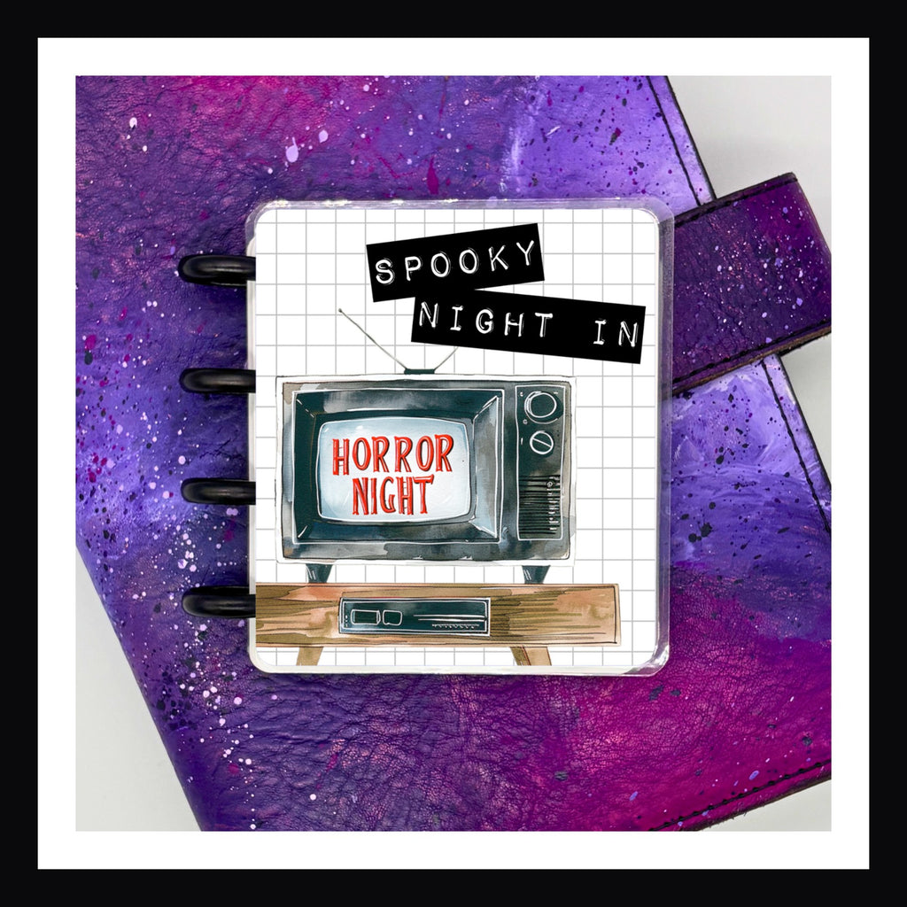 Spooky Night In Mini Sticker Book features 16 small pages of planner stickers disc bound in a laminated cover.  The theme focuses on a Halloween night spent indoors watching spooky movies.
