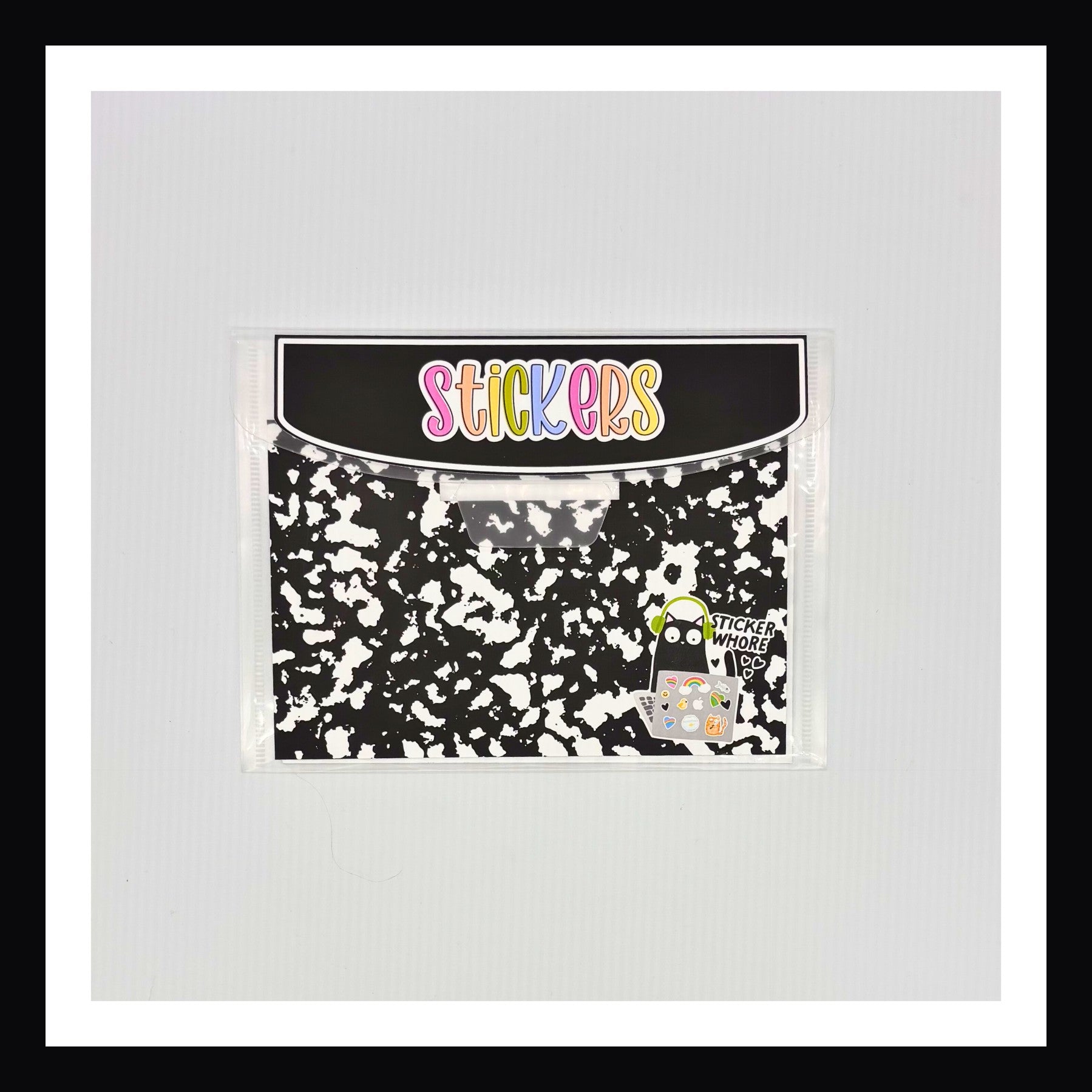 Plastic envelope with a composition notebook style outside. 