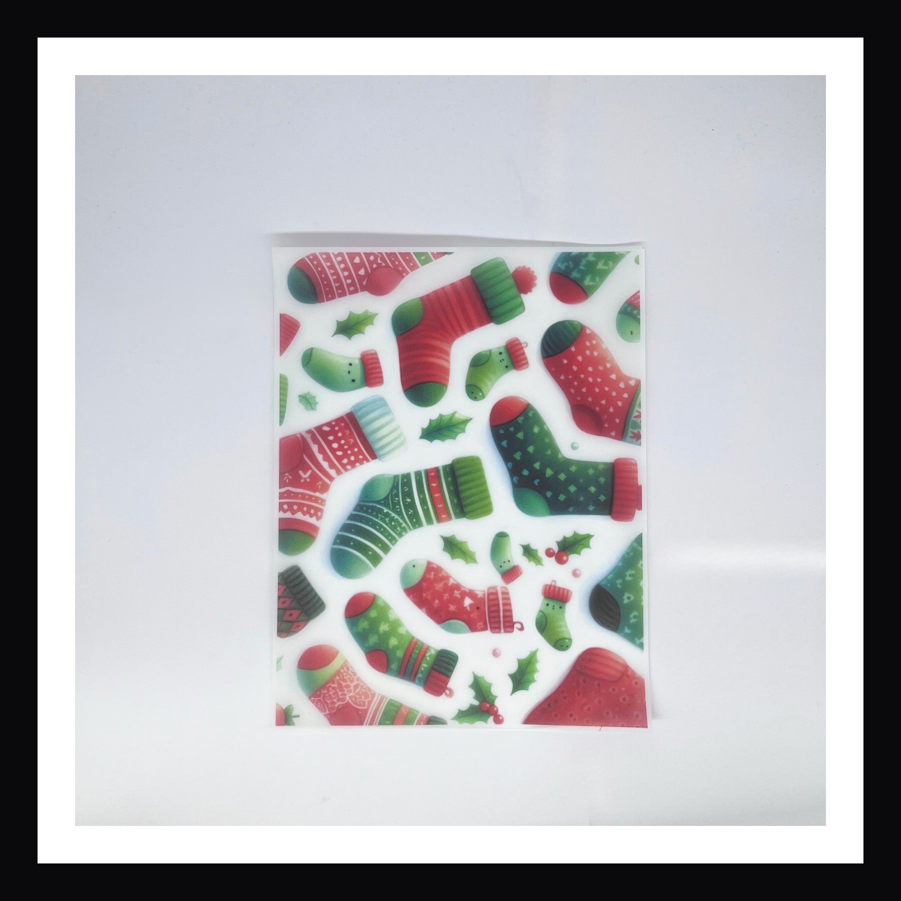 Christmas Morning Vellum - Stockings is a 8x10 sheet of printed vellum.  This print features a collection of Christmas stockings all with individual patterns and colors. 