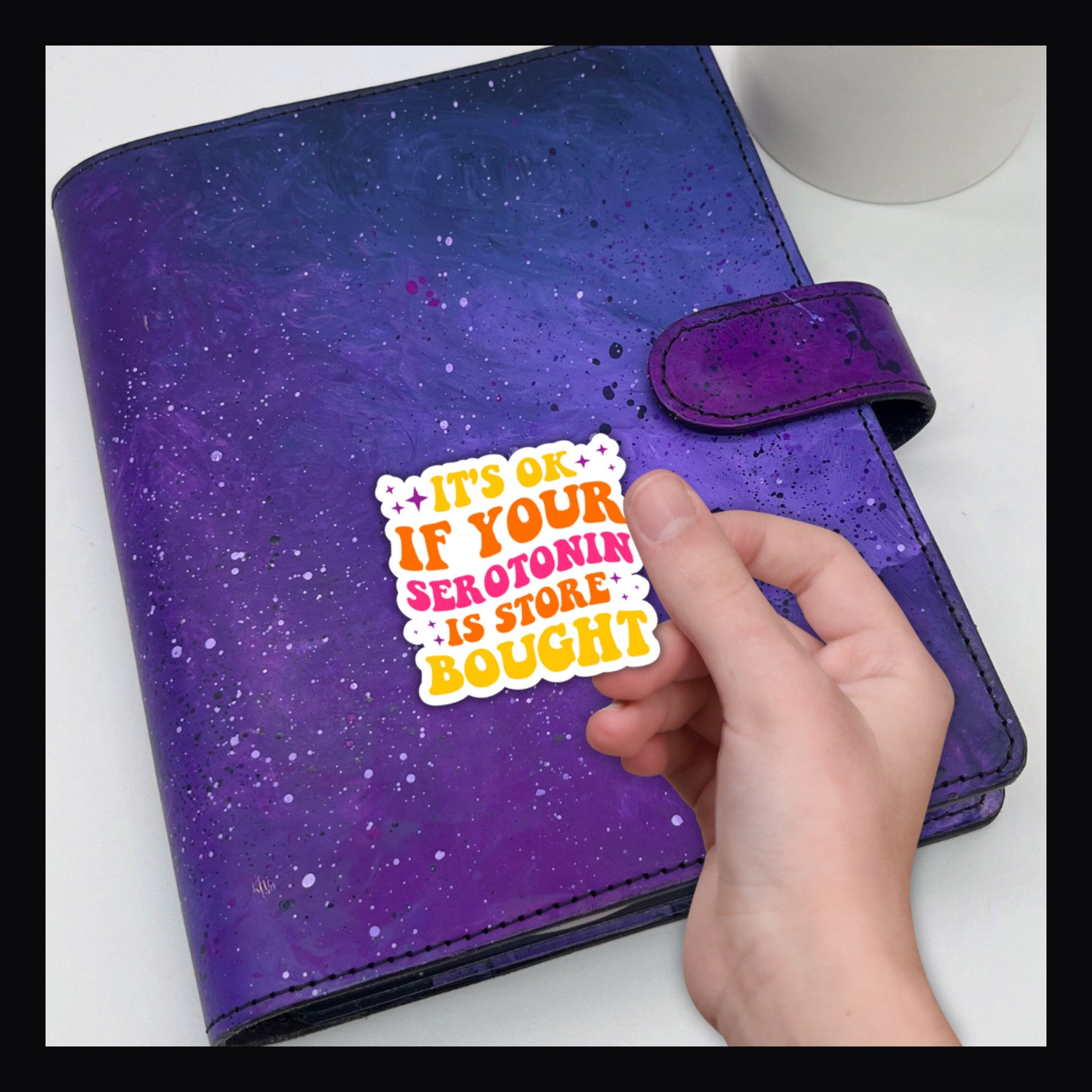 Store Bought Serotonin Die Cut reads "It's ok if your Serotonin is store bought" shown on a purple planner.