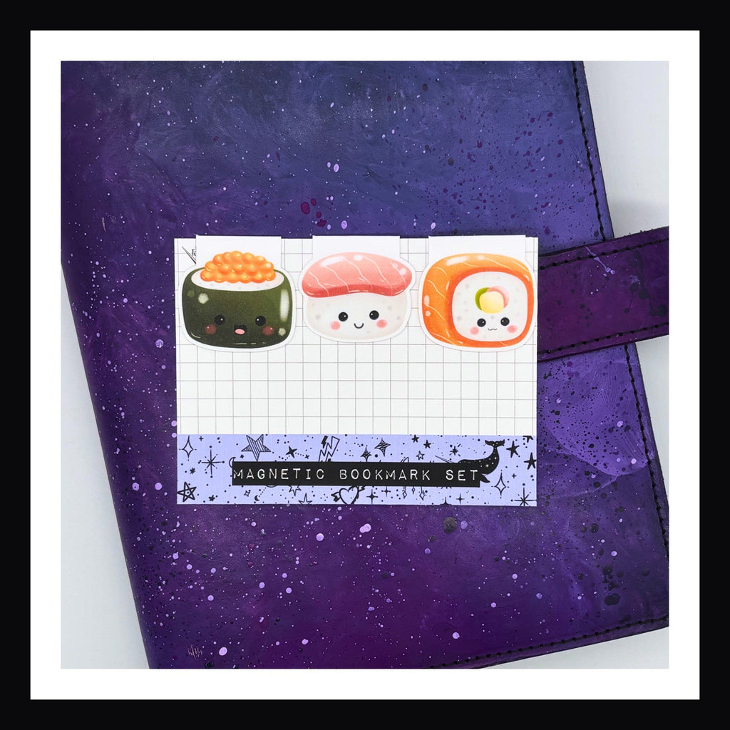 Magnetic Bookmark - Sushi Trio shown sitting on a purple planner.