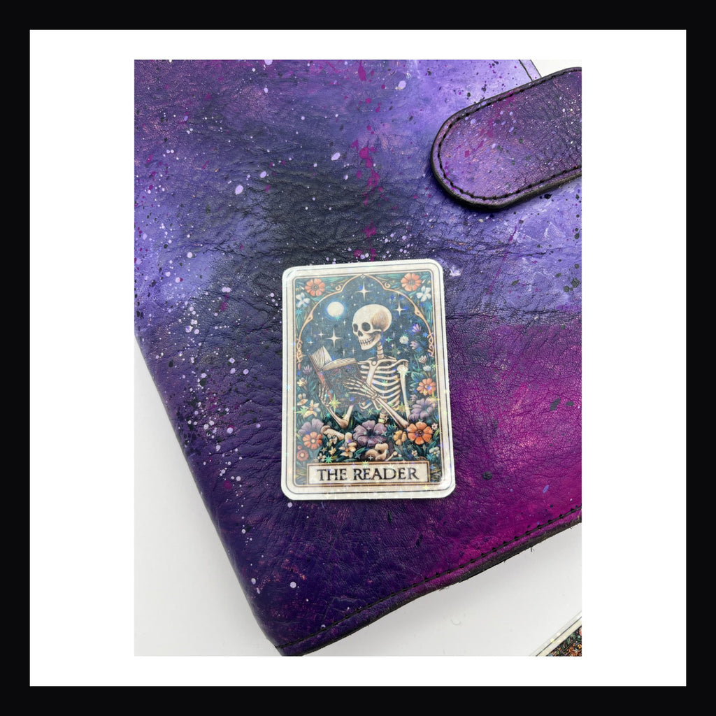 Alternative Tarot Die Cuts - The Reader is a holographic die cut sticker featuring a skeleton holding and reading a book.