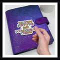 Thriving, Surviving, Crying Die Cut Sticker shown here on a purple planner.