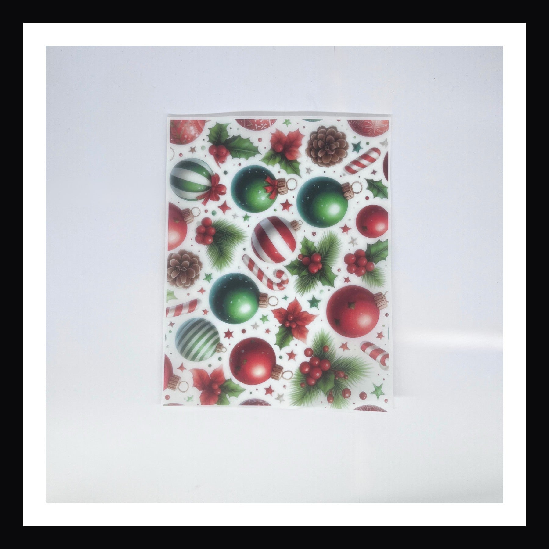 Christmas Morning Vellum - Tree Trimmings is a 8x10 sheet of printed vellum.  This print features a collection of Christmas ornaments, candy canes, pine cones and other various decor that is commonly found on Christmas trees.