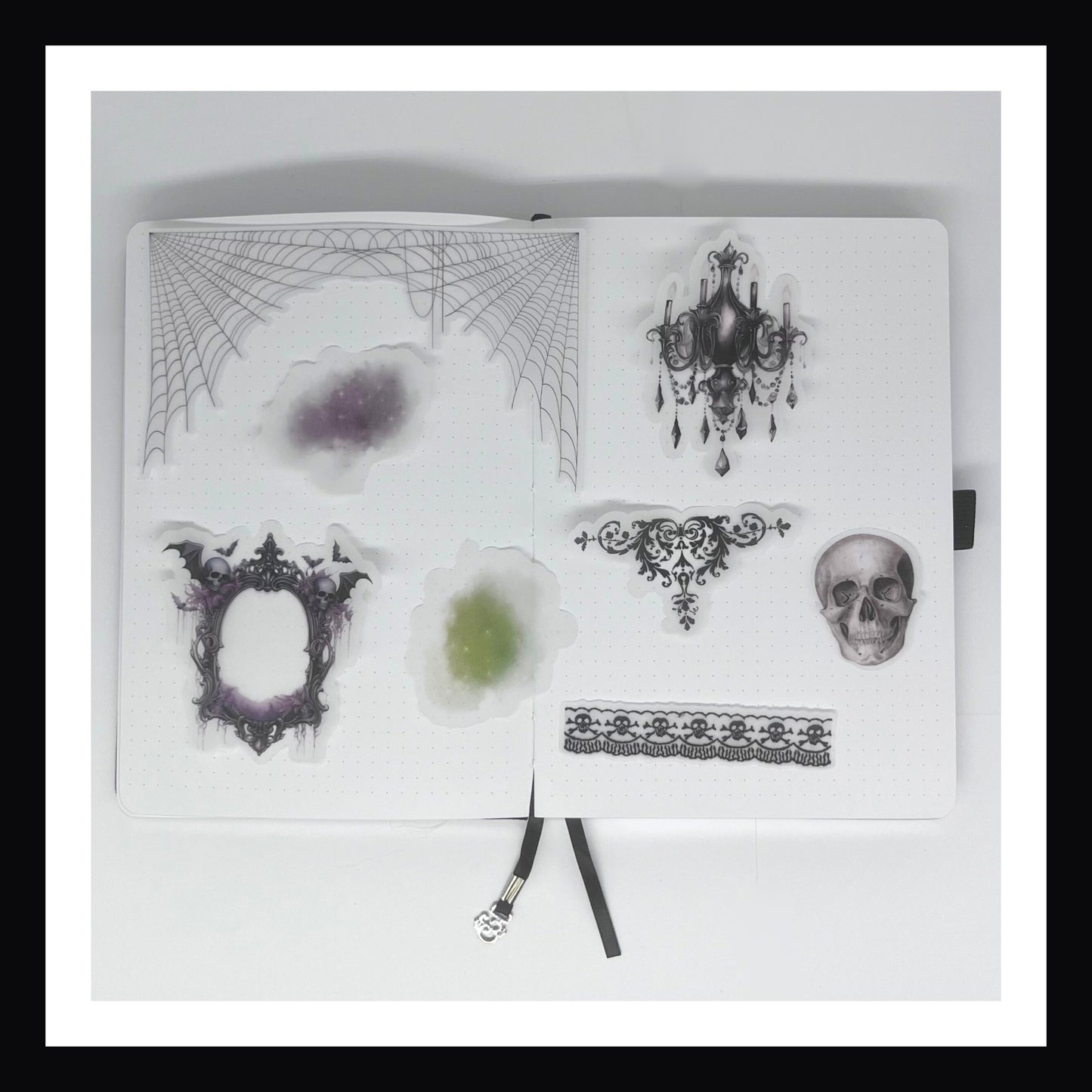 Deluxe Halloween Junk Journal Kit includes 8 vellum accents.  All accents are fancy kit and vary in size depending on the design.  Images include a skull, cobwebs, gothic frame, chandelier and decorative elements including some spooky fog/smoke.