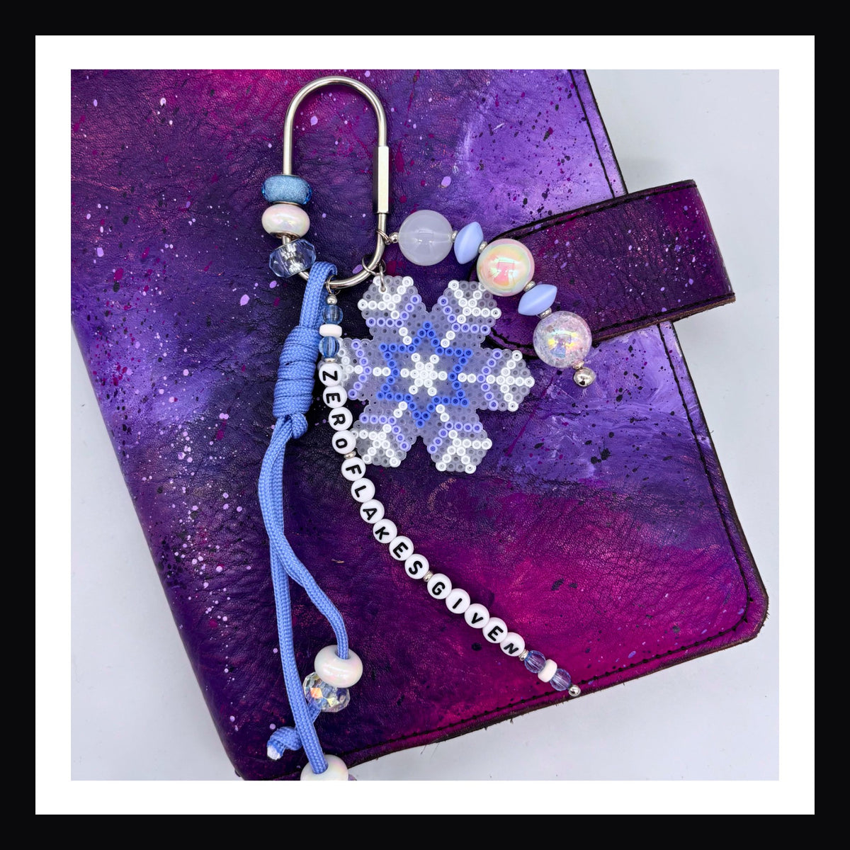 Zero Flakes Given Carabiner Bag Charm.  Featuring a handmade snowflake charm, and a beaded tag that reads "Zero Flakes Given" this bag charm will add some icy sparkle to any bag, backpack or planner.